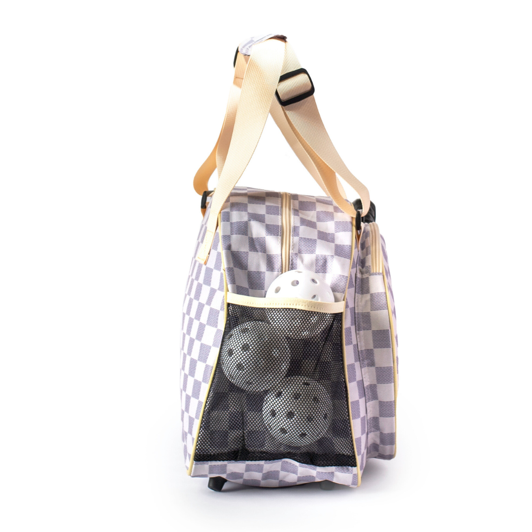 Checkered bag with pickleball balls on a white background