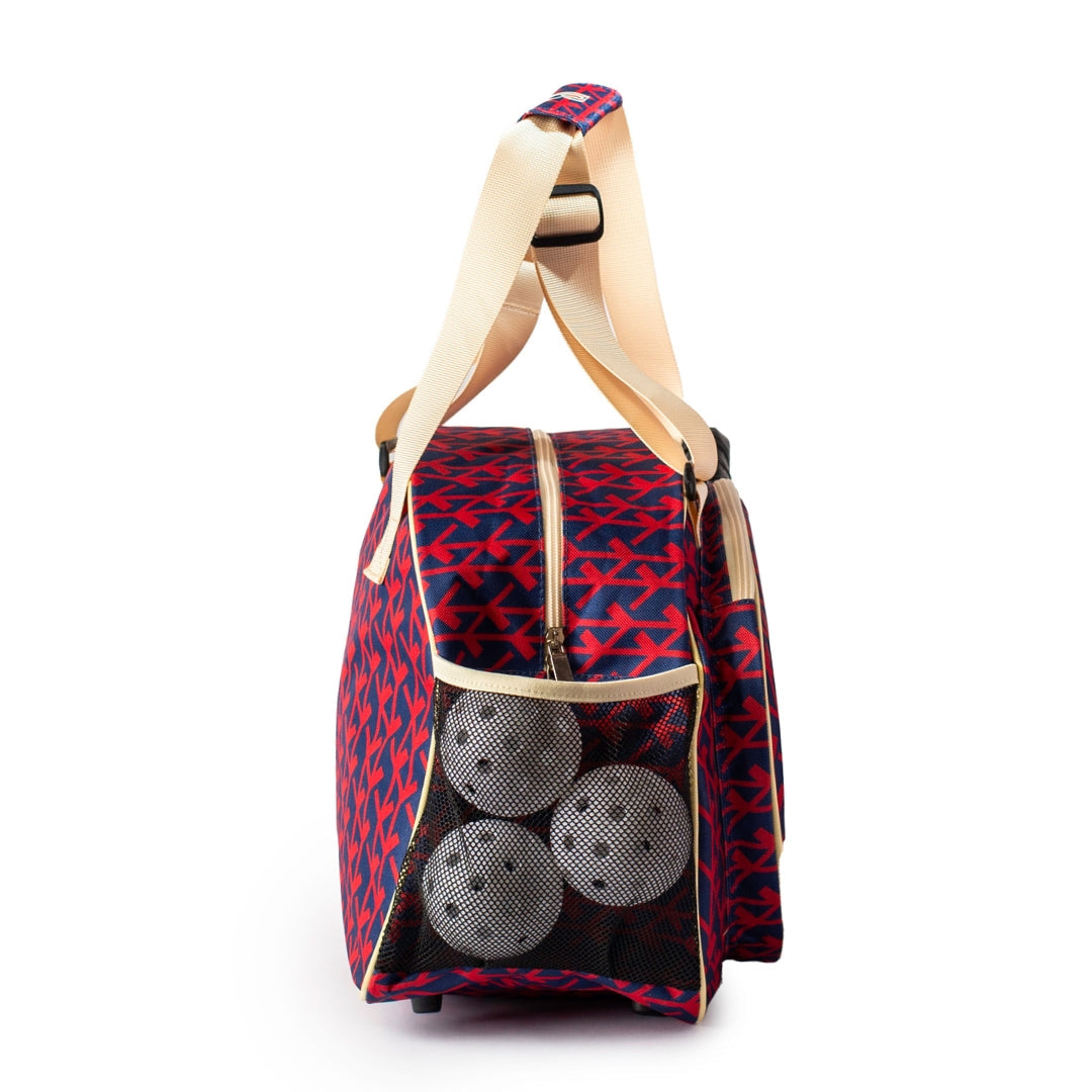 Red and blue patterned pickleball bag with three pickleballs on a white background