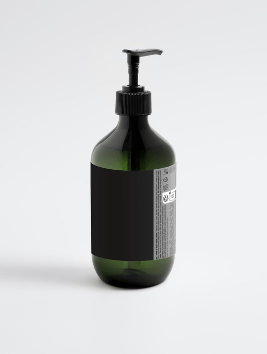 Brown bottle with black pump and labels on a white background