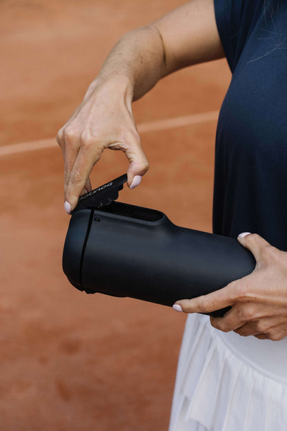 Person holding a black Bounce canister 