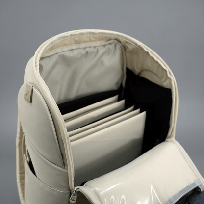 Beige backpack with compartments on a gray background