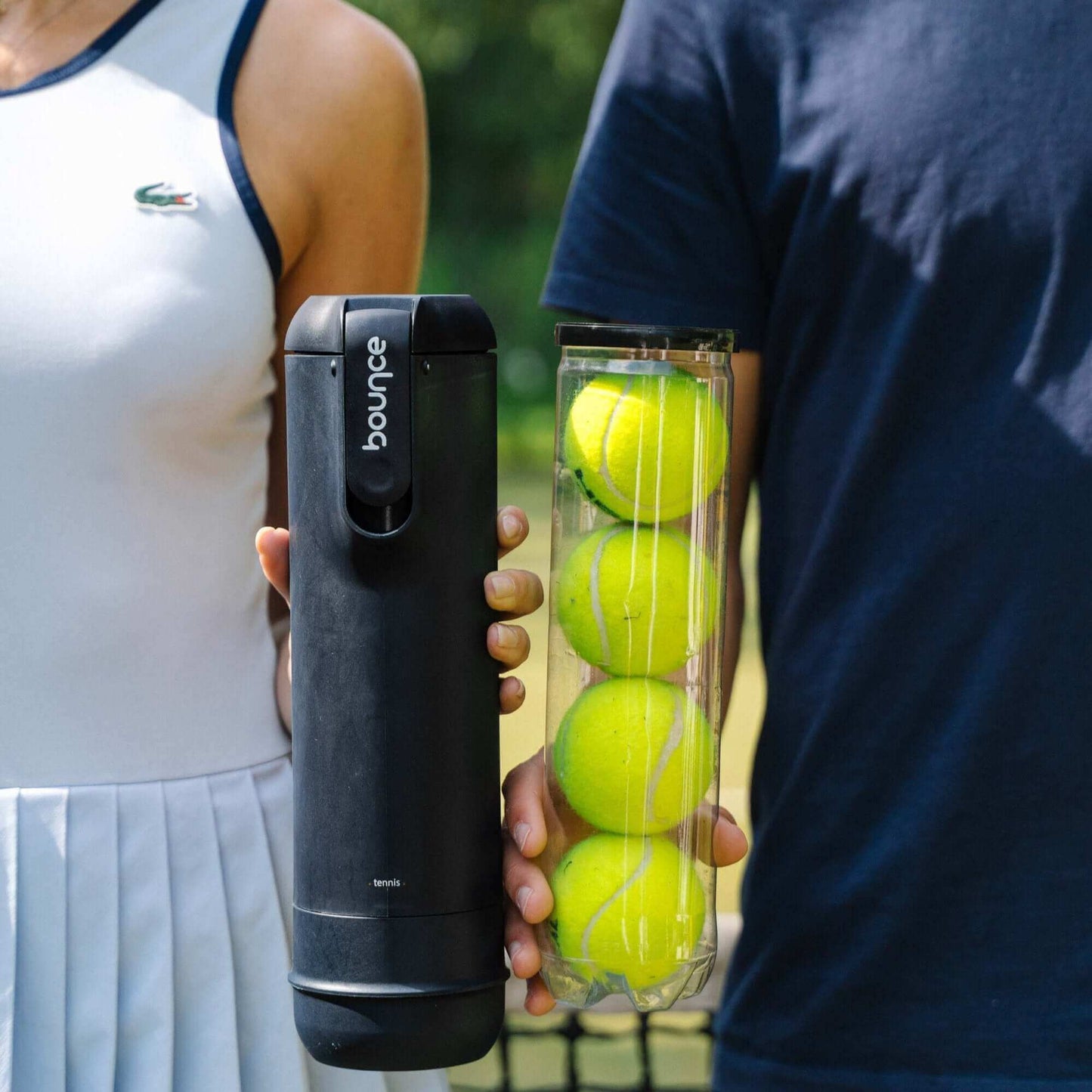 Person holding black bounce canister and person holding tennis ball can