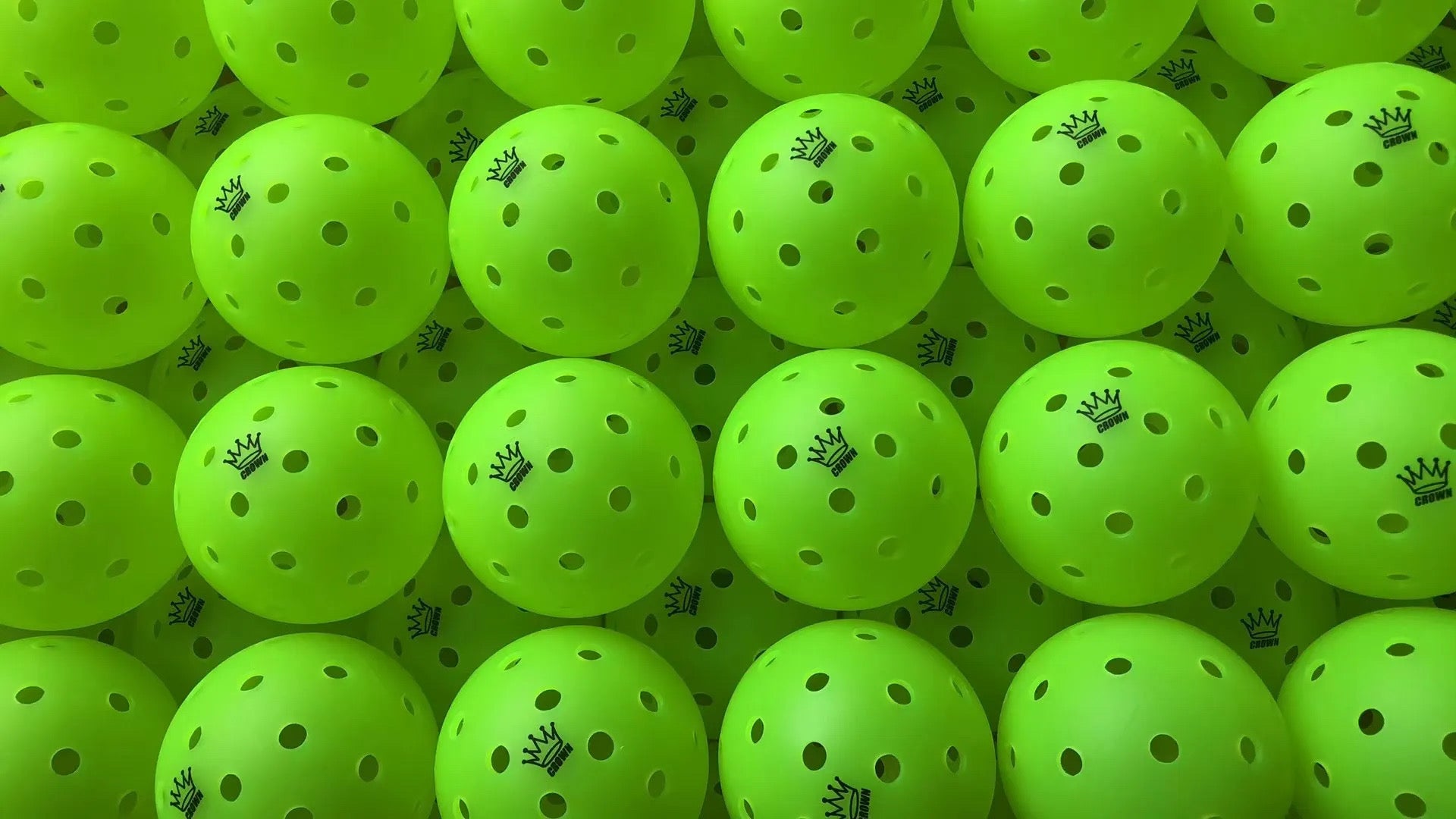Multiple green pickleballs with a brand logo on a green background