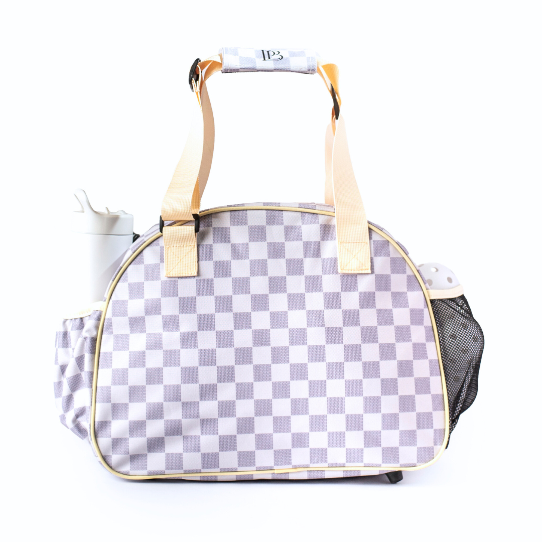 Checkered racquet bag with yellow straps on a white background