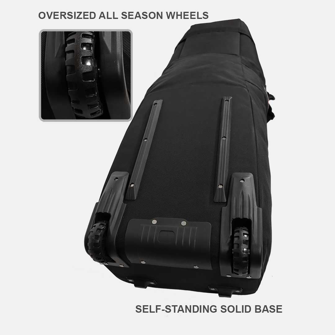 Black travel bag with oversized all-season wheels and self-standing solid base on a white background.