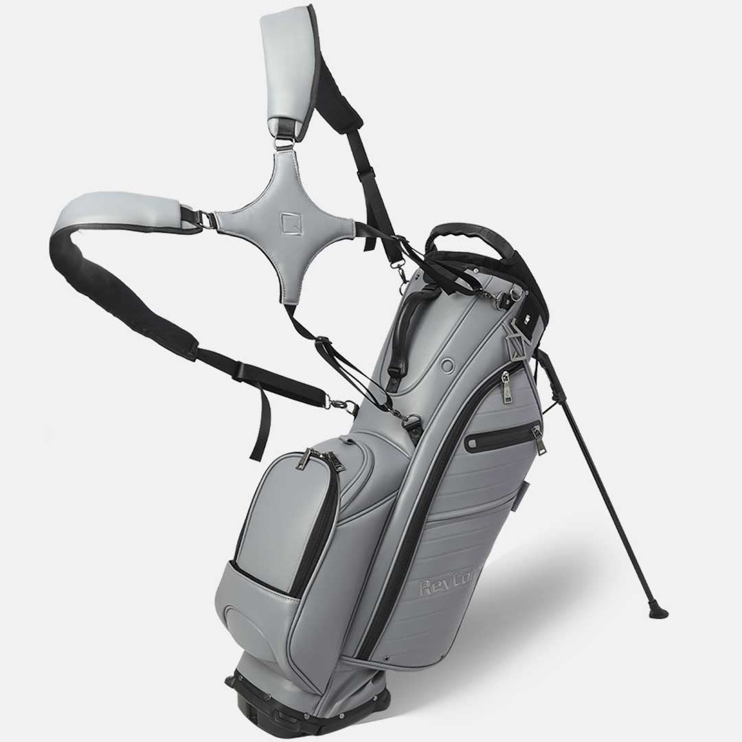 Gray golf bag with stand and club head cover on a white background