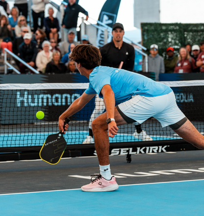 Tennis player in action on a court with spectators in the background
