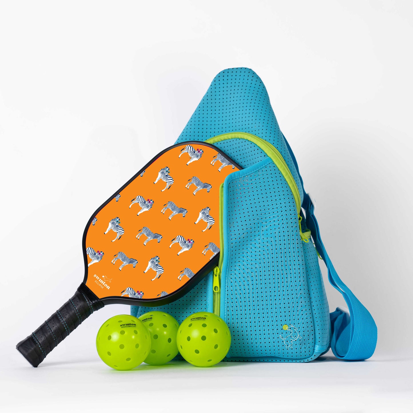 Blue pickleball bag with orange paddle featuring zebra pattern and green pickleballs on a white background