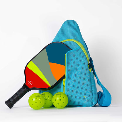 Blue pickleball bag with colorful paddle and green balls on a white background