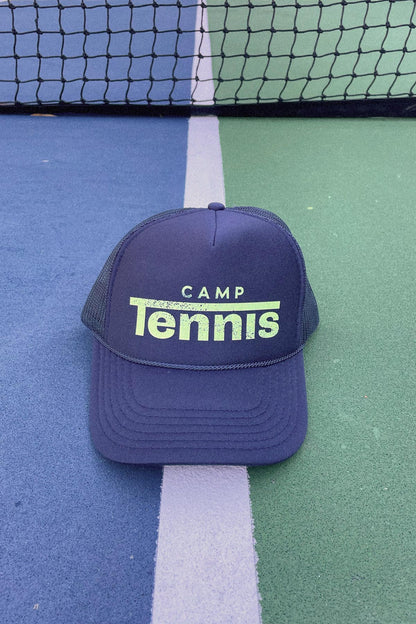 Blue cap with 'Camp Tennis' text on a tennis court