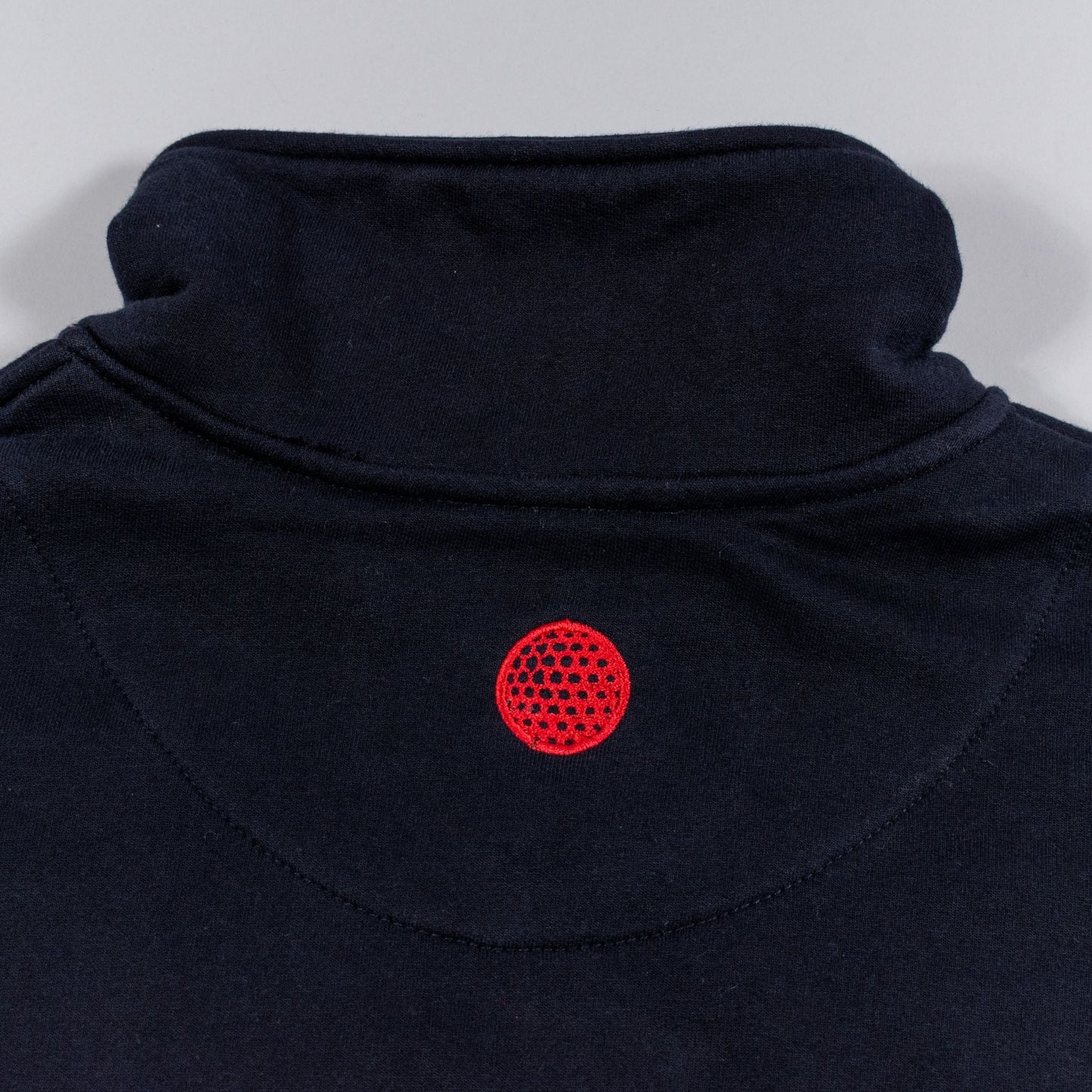 Black fleece with a red circular pattern on a white background