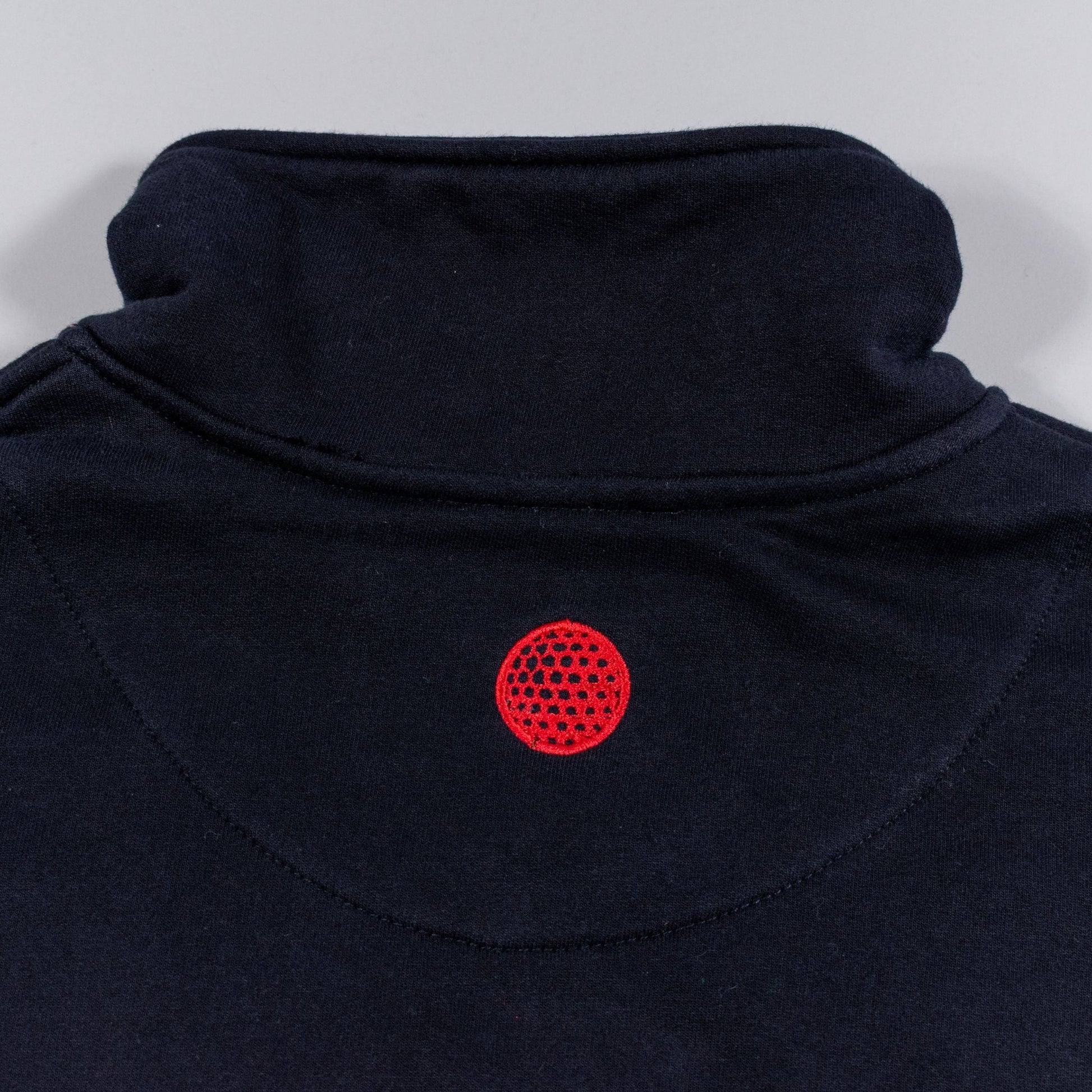 Black fleece with a red circular pattern on a white background