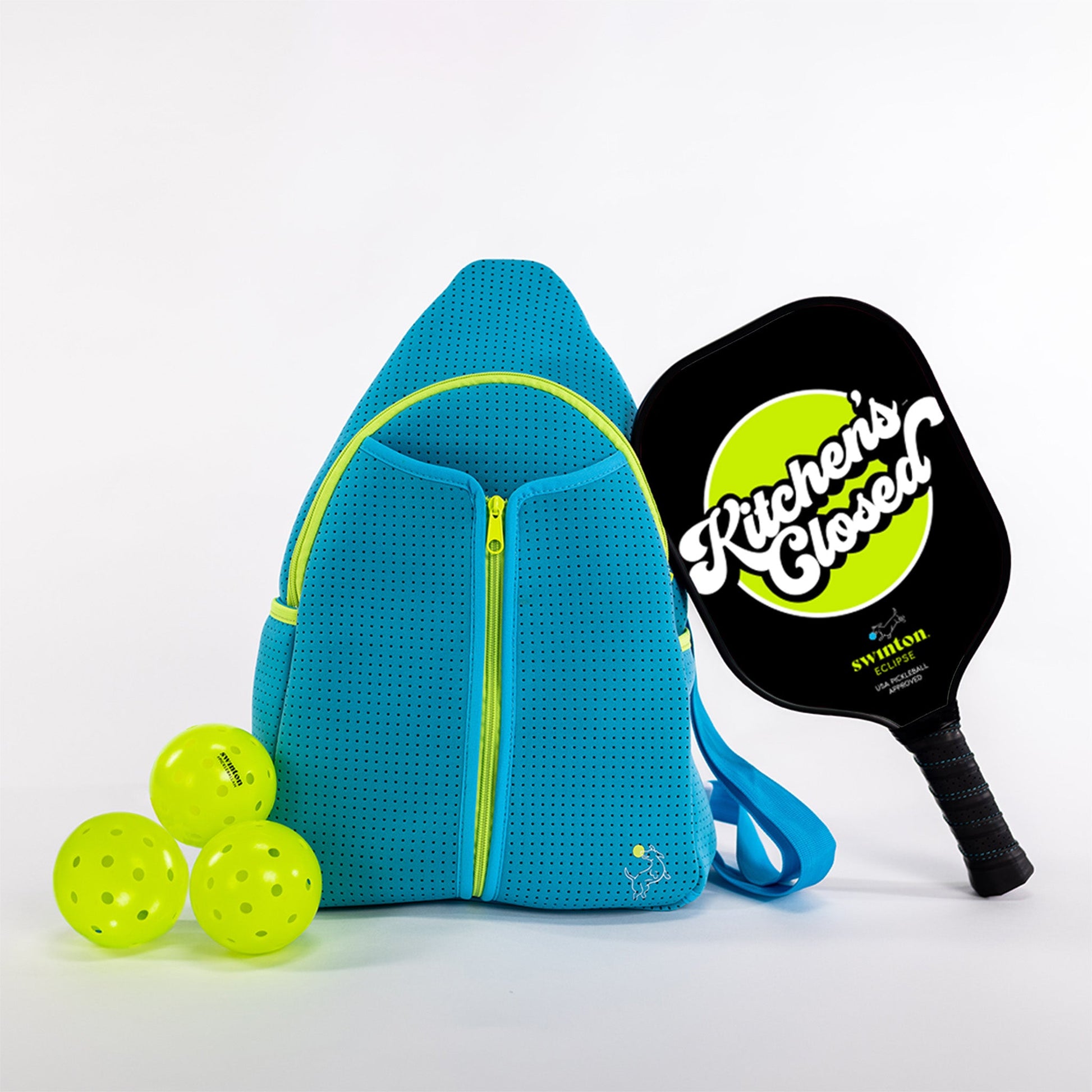 Blue pickleball bag with three green pickleballs and a black paddle on a white background
