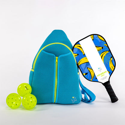Blue pickleball bag with three green pickleballs and a blue pickleball paddle with banana design on a white background