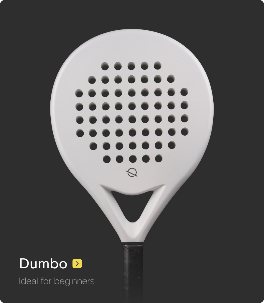 White paddle with black perforated surface on a black background, labeled 'Dumbo'.