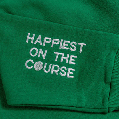Green sweatshirt with 'Happiest on the Course' text and golf ball design.