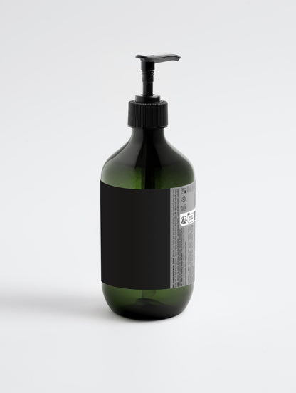 Brown bottle with black pump and labels on a white background
