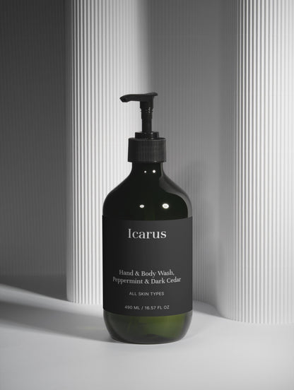 Black bottle of QEROE hand and body wash with a pump on a light gray background