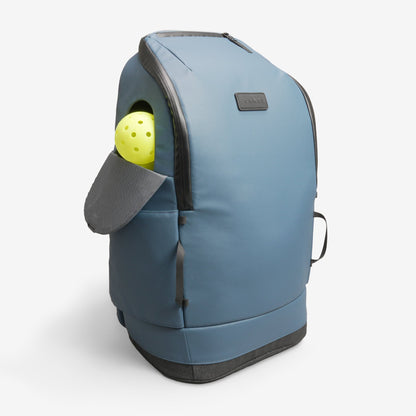 Blue pet carrier with a yellow ball inside on a white background