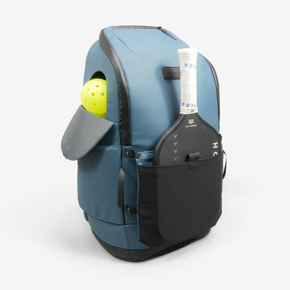 Blue backpack with a pickleball paddle and ball on a white background