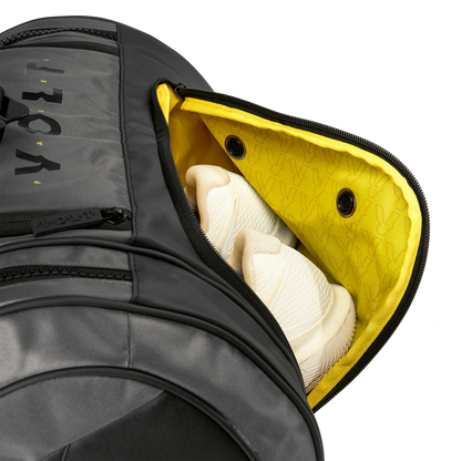Gray guitar case with a yellow interior, showing a white guitar inside.