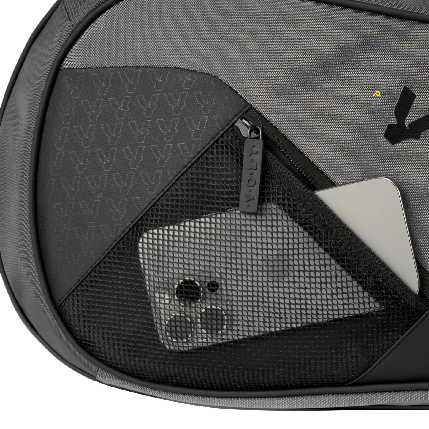 Gray backpack with a mesh pocket containing a smartphone and other items.