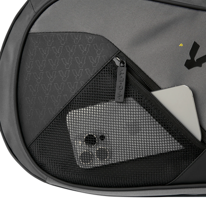 Gray backpack with a mesh pocket containing a smartphone and other items.