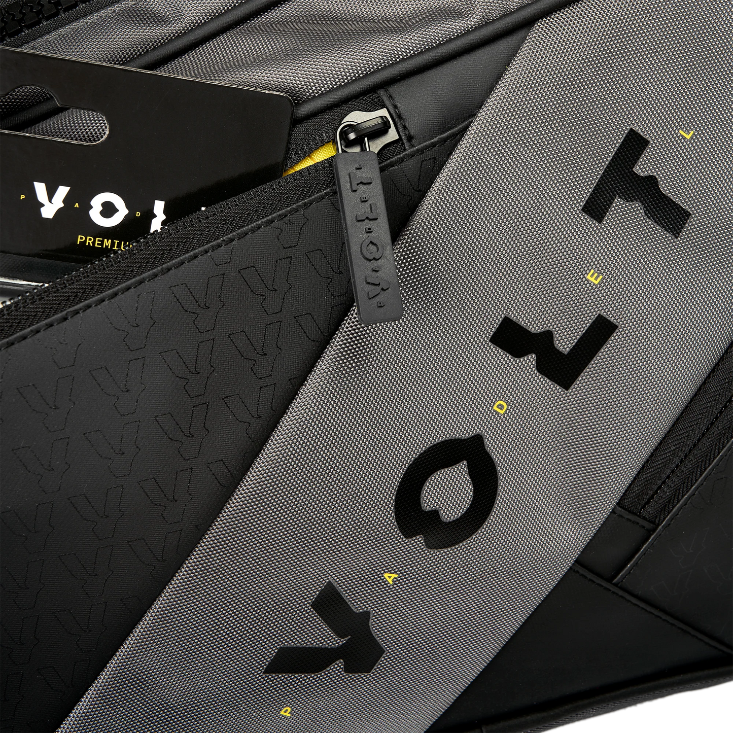 Close-up of a gray and black bag with 'Voy' branding.