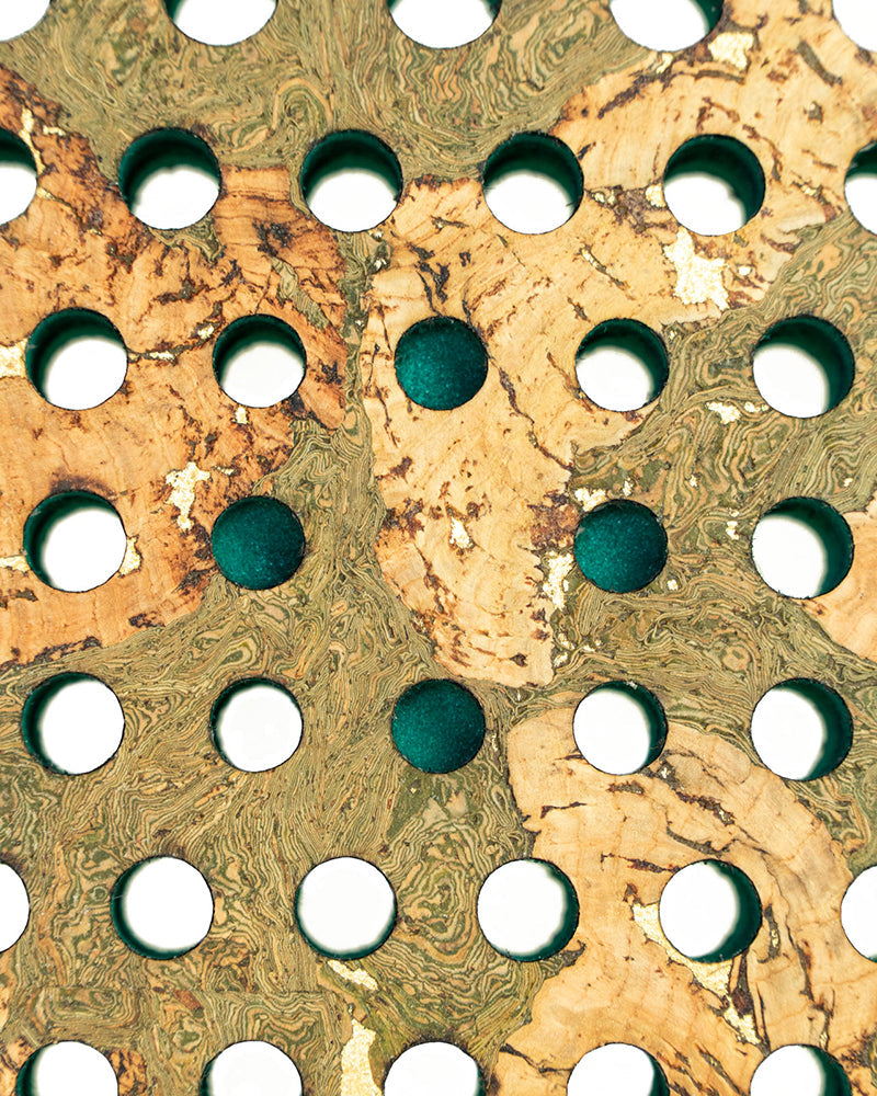 Close-up of a marbled paper texture with circular holes.