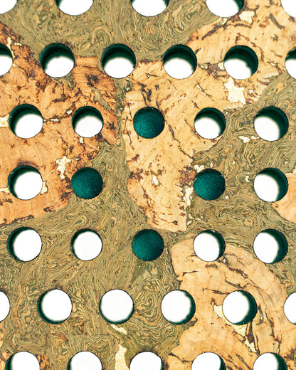 Close-up of a marbled paper texture with circular holes.