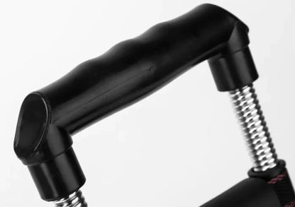 Black hand gripper with spring mechanism on a white background